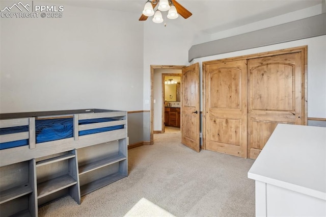 bedroom with light carpet, baseboards, and a ceiling fan