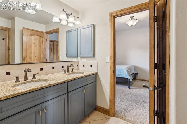 full bath with double vanity, backsplash, a sink, and tile patterned floors