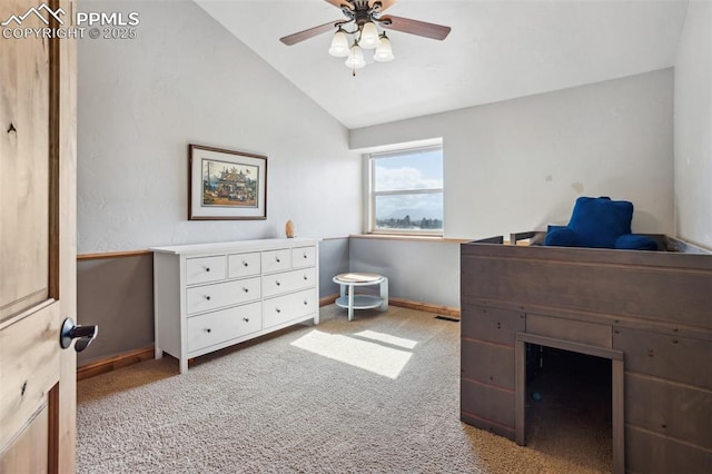 office area with lofted ceiling, baseboards, a ceiling fan, and light colored carpet