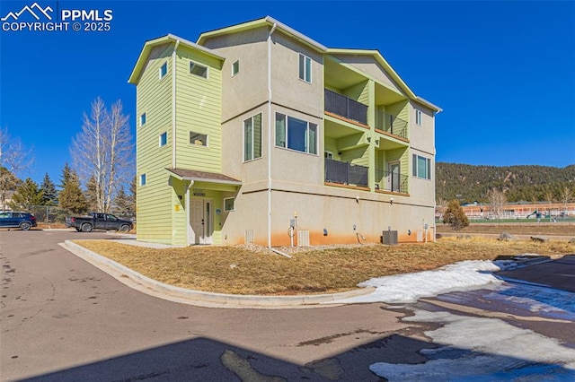 view of home's exterior with central air condition unit and stucco siding