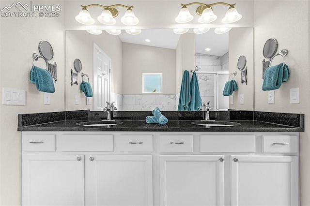 bathroom featuring double vanity, vaulted ceiling, a shower stall, and a sink