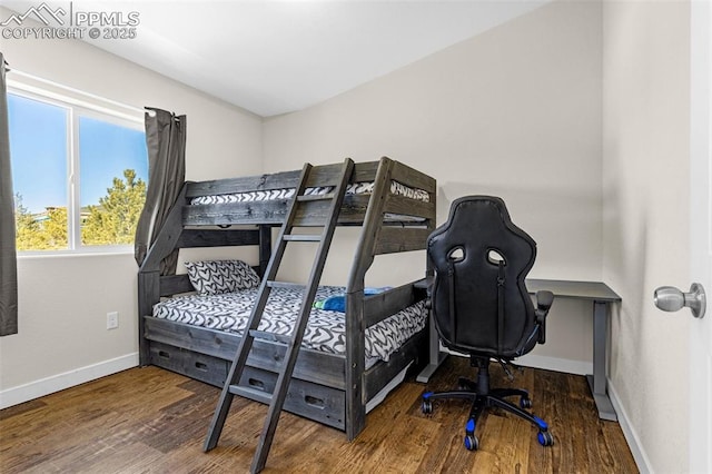 bedroom featuring baseboards and wood finished floors