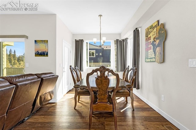 dining room featuring dark wood-style floors, baseboards, and a chandelier