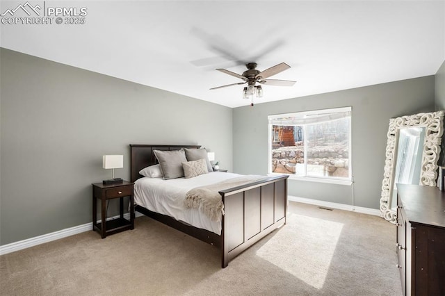 bedroom featuring light carpet, a ceiling fan, visible vents, and baseboards