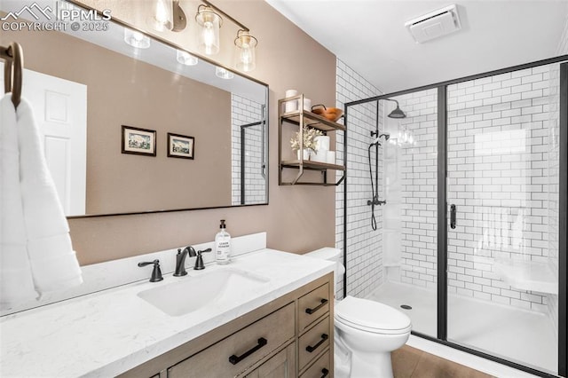 bathroom featuring a stall shower, visible vents, vanity, and toilet