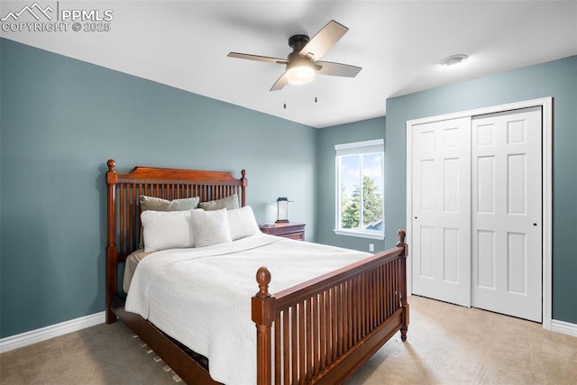 carpeted bedroom featuring a closet, ceiling fan, and baseboards