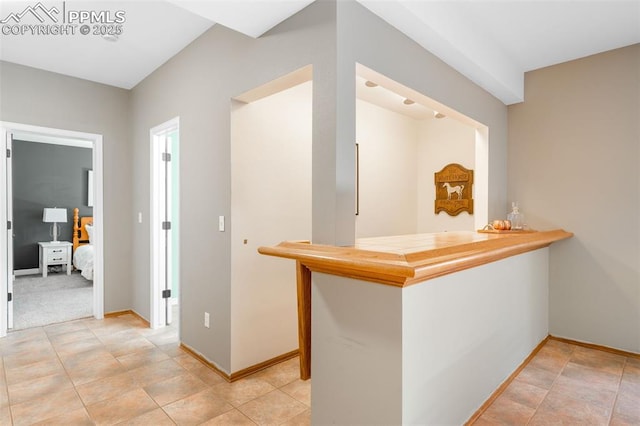 interior space with a dry bar and baseboards