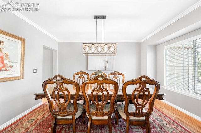 dining area with ornamental molding, light wood-type flooring, and baseboards