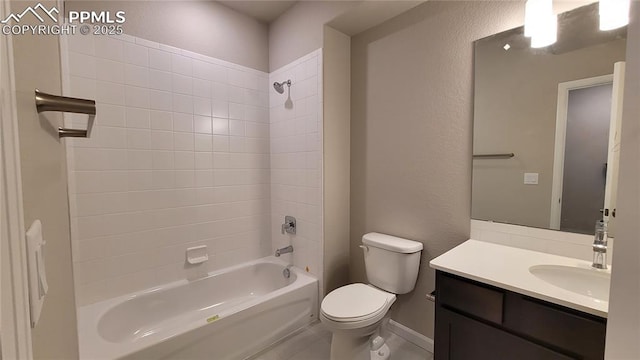 9463 Jollity Pt, Colorado Springs, CO 80924 - bathroom with a textured wall, baseboards, toilet, bathing tub / shower combination, and vanity