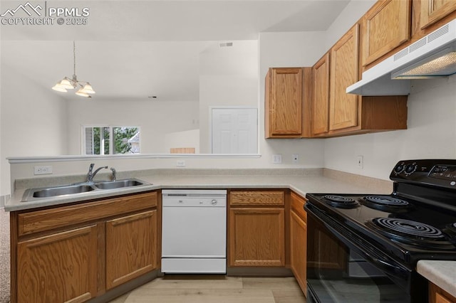 kitchen featuring black range with electric cooktop, under cabinet range hood, light countertops, white dishwasher, and a sink