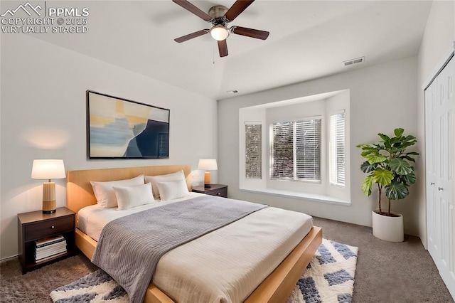 bedroom with visible vents, carpet floors, a closet, and ceiling fan