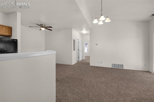 unfurnished living room with ceiling fan with notable chandelier, visible vents, and carpet floors