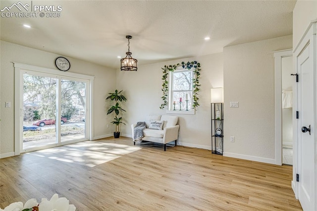 unfurnished room with recessed lighting, light wood-style flooring, and baseboards