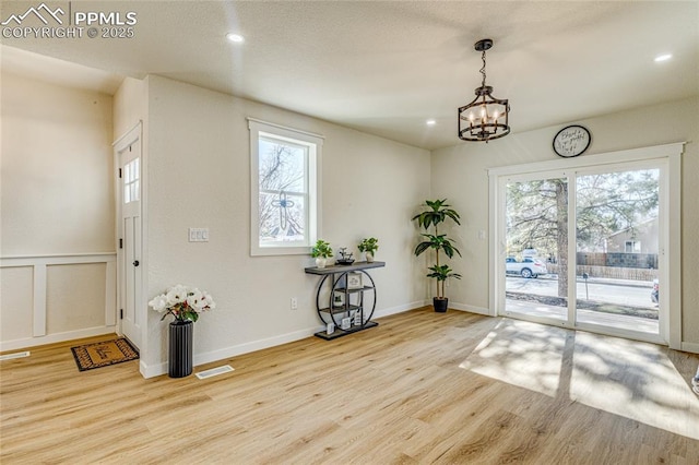 interior space with recessed lighting, wood finished floors, visible vents, and a healthy amount of sunlight