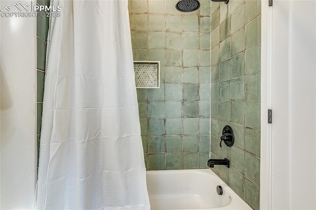 bathroom with shower / tub combo with curtain