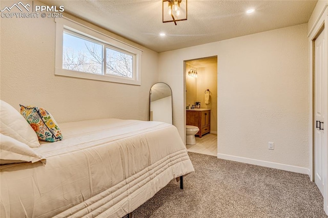 carpeted bedroom featuring recessed lighting, baseboards, and ensuite bathroom