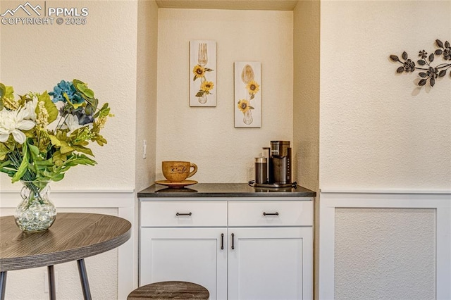 bar featuring a wainscoted wall