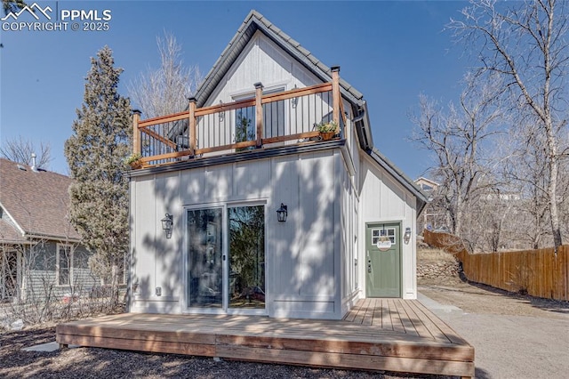 back of house featuring a deck and fence