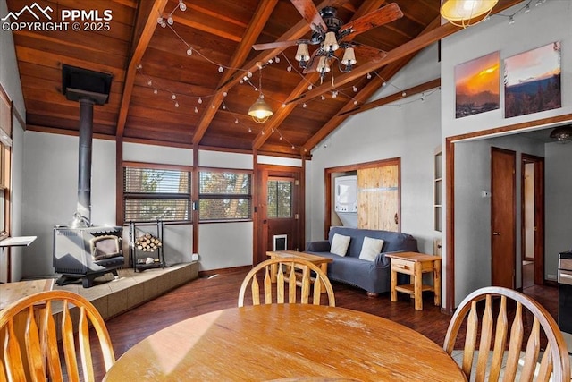 dining space featuring beam ceiling, wooden ceiling, wood finished floors, and a wood stove