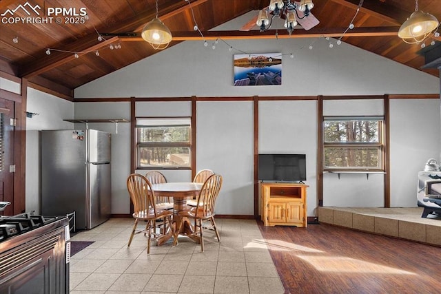 dining room featuring plenty of natural light, wooden ceiling, and vaulted ceiling with beams