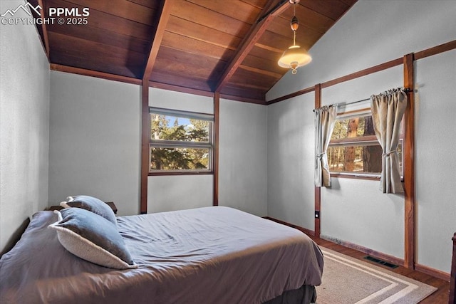 bedroom with baseboards, visible vents, wooden ceiling, wood finished floors, and vaulted ceiling with beams