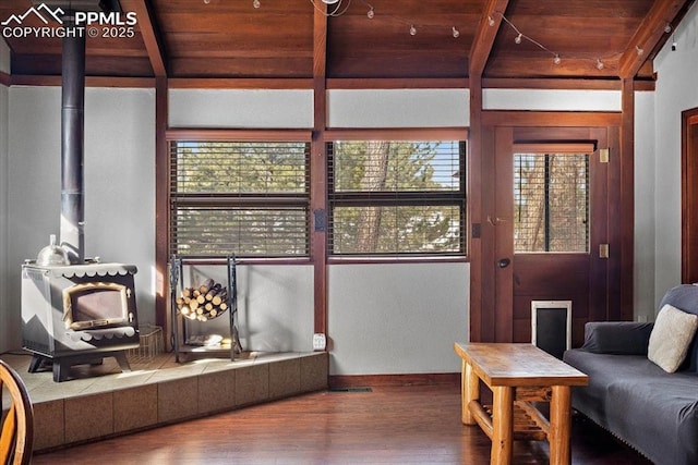 living room with wooden ceiling, beamed ceiling, and wood finished floors