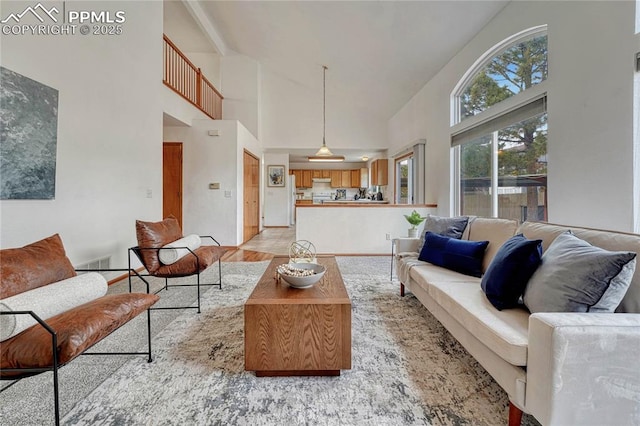 living area featuring visible vents and vaulted ceiling