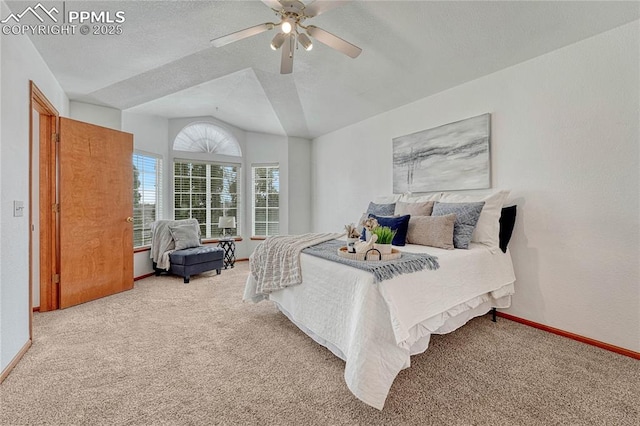 bedroom with vaulted ceiling, carpet floors, a ceiling fan, and baseboards