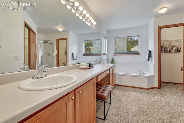 full bathroom featuring a garden tub, double vanity, a stall shower, and a sink