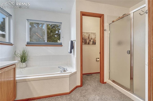 bathroom featuring a stall shower, carpet, baseboards, and a garden tub