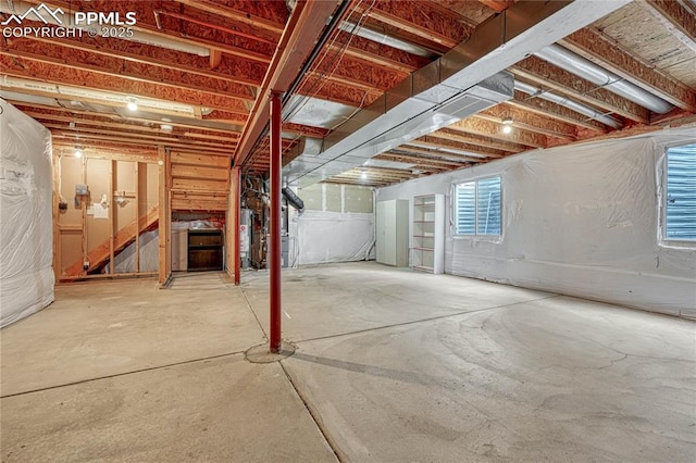 basement featuring gas water heater and heating unit