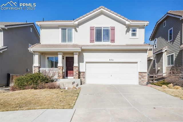 view of front of home with stone siding, concrete driveway, a tiled roof, and stucco siding