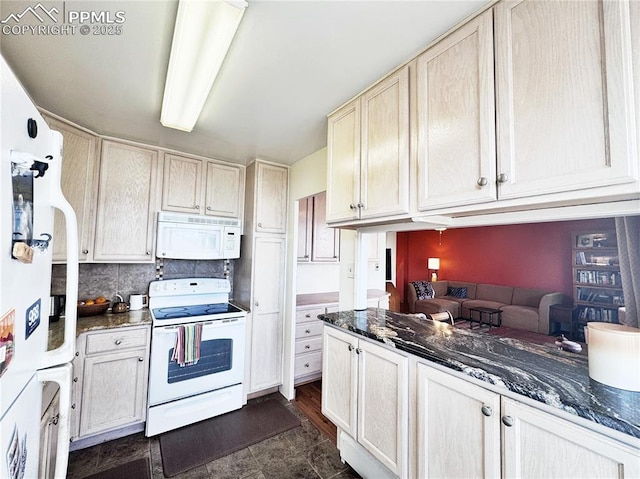 kitchen featuring tasteful backsplash, dark stone counters, and white appliances