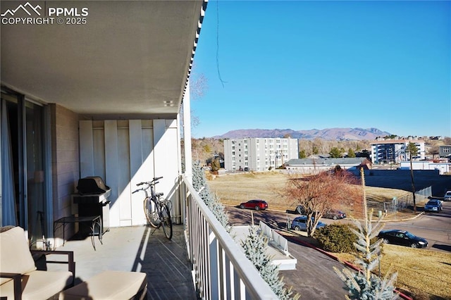 balcony featuring a view of city, a mountain view, and grilling area