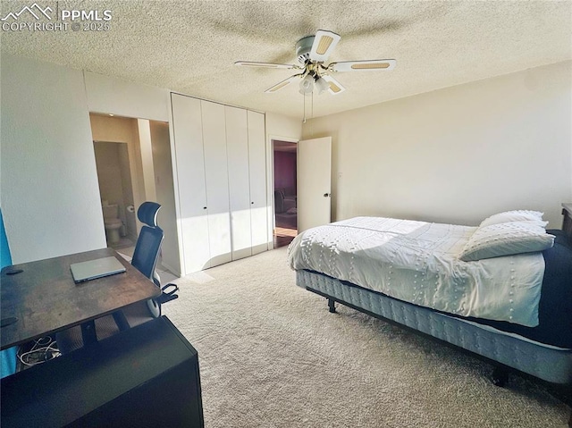 carpeted bedroom with a textured ceiling, a closet, and a ceiling fan