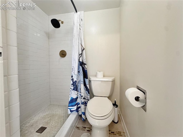 full bath featuring baseboards, a shower stall, toilet, and tile patterned floors