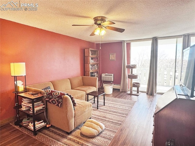 living area featuring a ceiling fan, baseboards, floor to ceiling windows, and wood finished floors