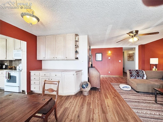 kitchen featuring white appliances, wood finished floors, light countertops, backsplash, and open shelves