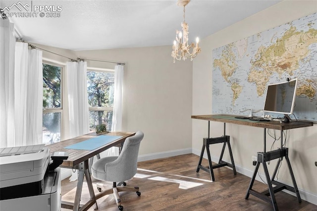 office space with a notable chandelier, wood finished floors, and baseboards