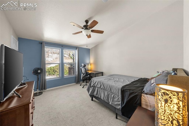 carpeted bedroom with ceiling fan, baseboards, and lofted ceiling
