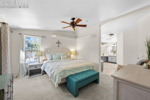 bedroom featuring ensuite bathroom, ceiling fan, and carpet floors