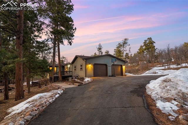 view of front of home featuring aphalt driveway and a garage