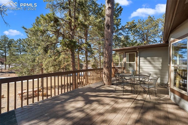 wooden deck with outdoor dining space