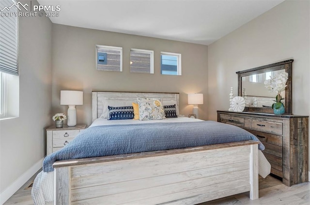 bedroom featuring wood finished floors and baseboards