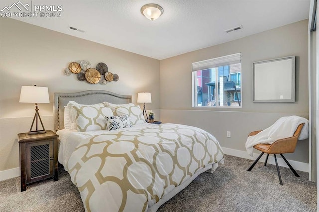 carpeted bedroom with visible vents and baseboards