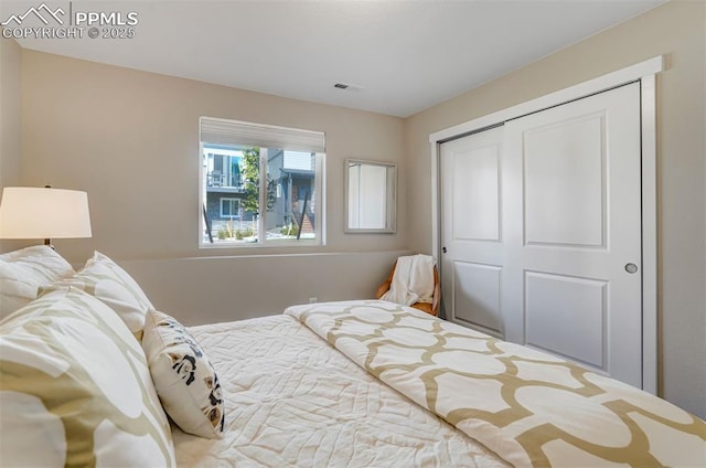 bedroom featuring a closet and visible vents