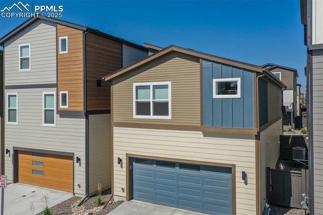 view of front facade featuring concrete driveway, board and batten siding, and an attached garage