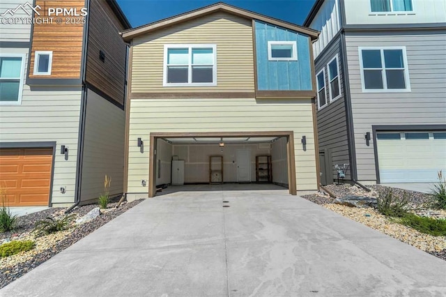 modern home featuring board and batten siding, concrete driveway, and an attached garage