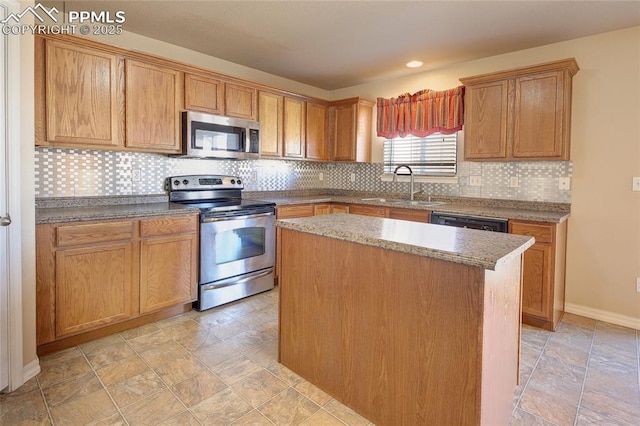 kitchen featuring a kitchen island, a sink, baseboards, appliances with stainless steel finishes, and decorative backsplash