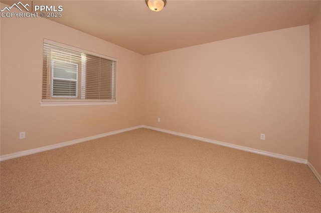 carpeted spare room with baseboards